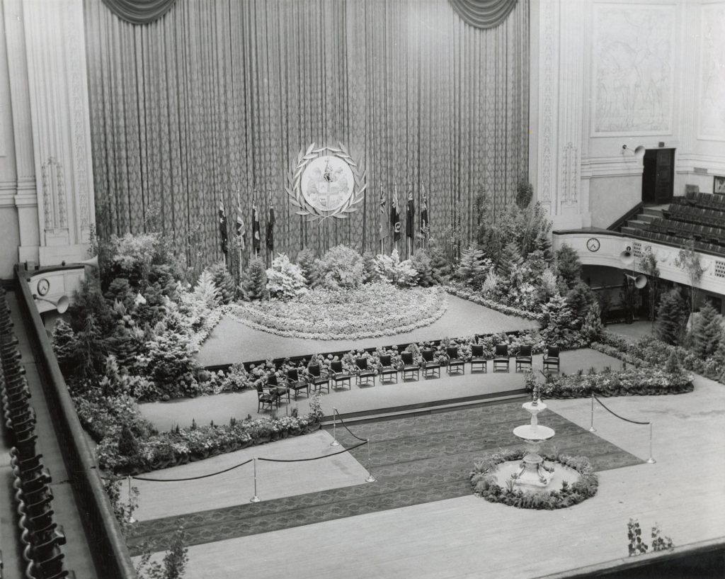 Image of the interior of Melbourne Town Hall, decorated for the reception of UK Prime Minister Harold Macmillan