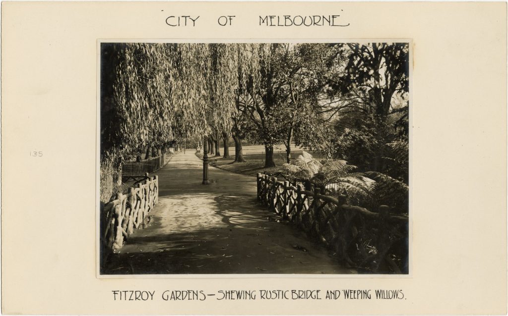 Image of a rustic bridge and weeping willows in Fitzroy Gardens