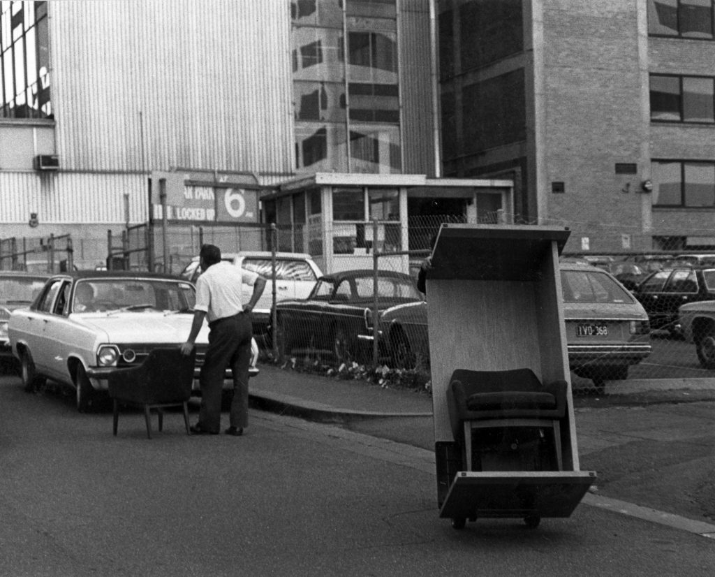Men Moving Furniture Down Street on Trolley