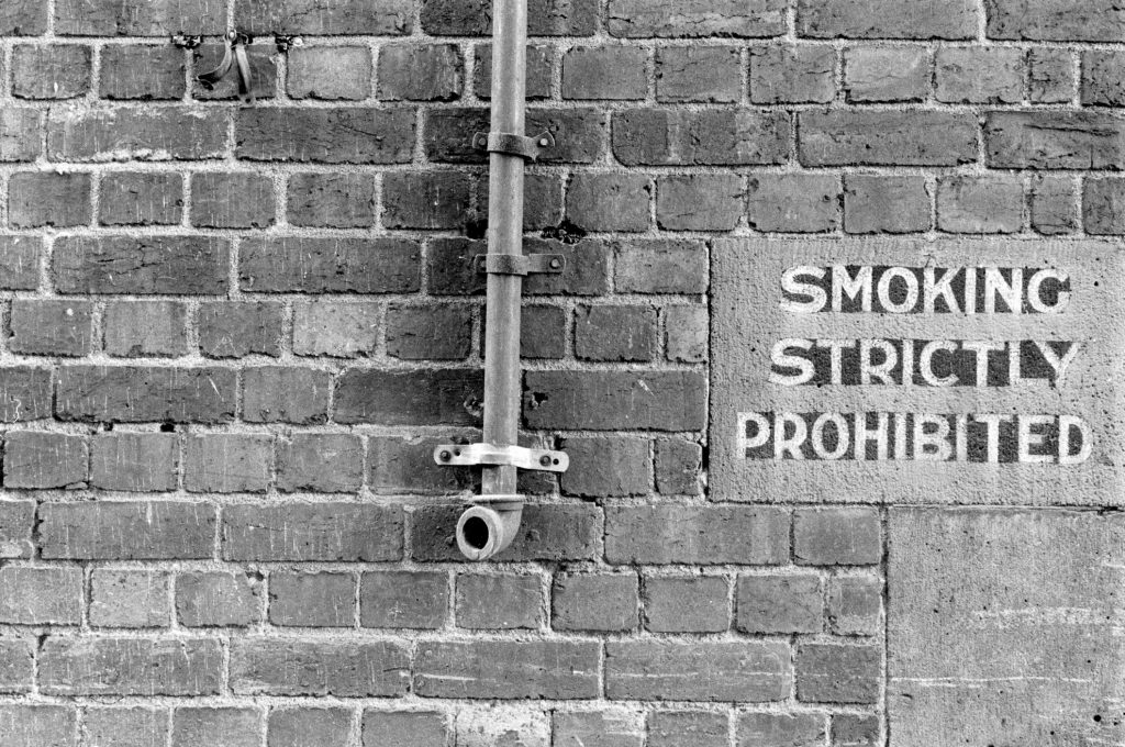 Brick Wall with Sign, ‘Smoking Strictly Prohibited’